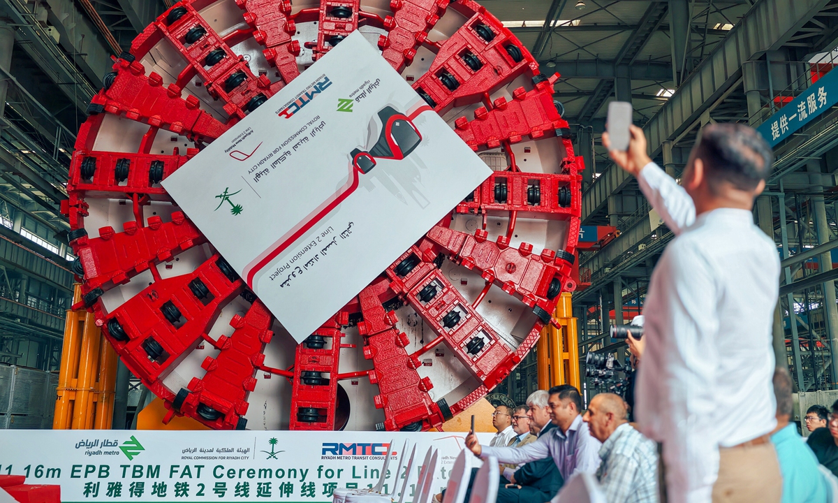 A guest takes a photo at the roll-off ceremony of China's first shield tunneling machine exported to Saudi Arabia in North China's Tianjin on July 2, 2026. The machine will be deployed for construction of the Riyadh Metro Line 2 extension project. Photo: VCG