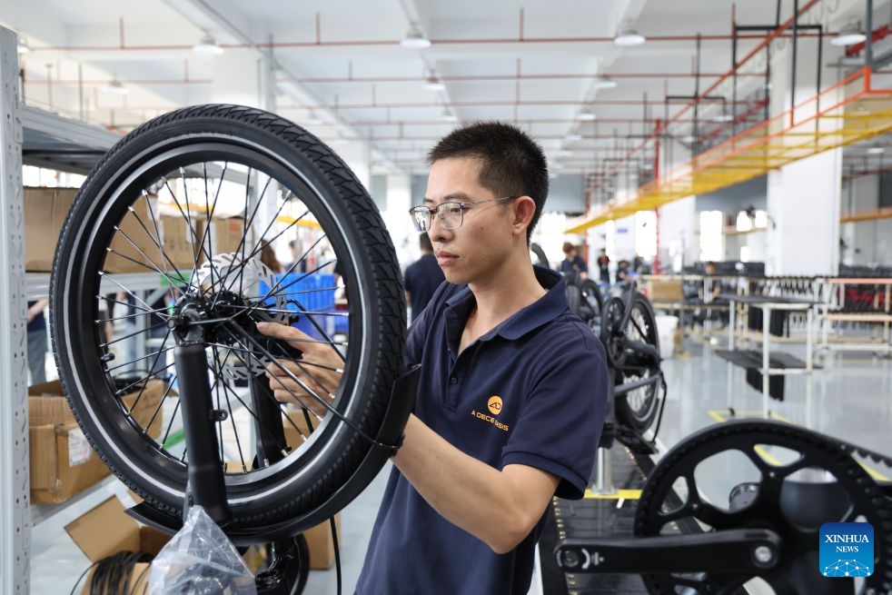 A staff member works at the ADO e-bike workshop of Huizhou Ruijianxing New Energy Technology Co., Ltd. in Huizhou, south China's Guangdong Province, July 1, 2026. Huizhou Ruijianxing New Energy Technology Co., Ltd. is an e-bike manufacturer headquartered in Huizhou. Its brand, ADO e-bike, integrates AI-powered sensing technology to make riding smarter and safer. (Photo: Xinhua)