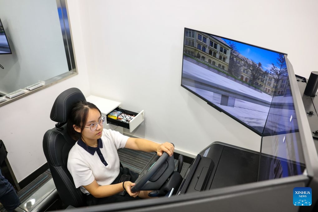 A student operates a driving simulator at the Transportation Behavioral Psychology and Safety Lab of the Hong Kong University of Science and Technology (Guangzhou) in Guangzhou, south China's Guangdong Province, June 30, 2026. Hong Kong University of Science and Technology (Guangzhou), which opened in 2022, has adopted an innovative academic structure featuring Hubs and Thrusts instead of traditional schools and departments, aiming to foster an interdisciplinary education model and advance emerging disciplines. (Photo: Xinhua)