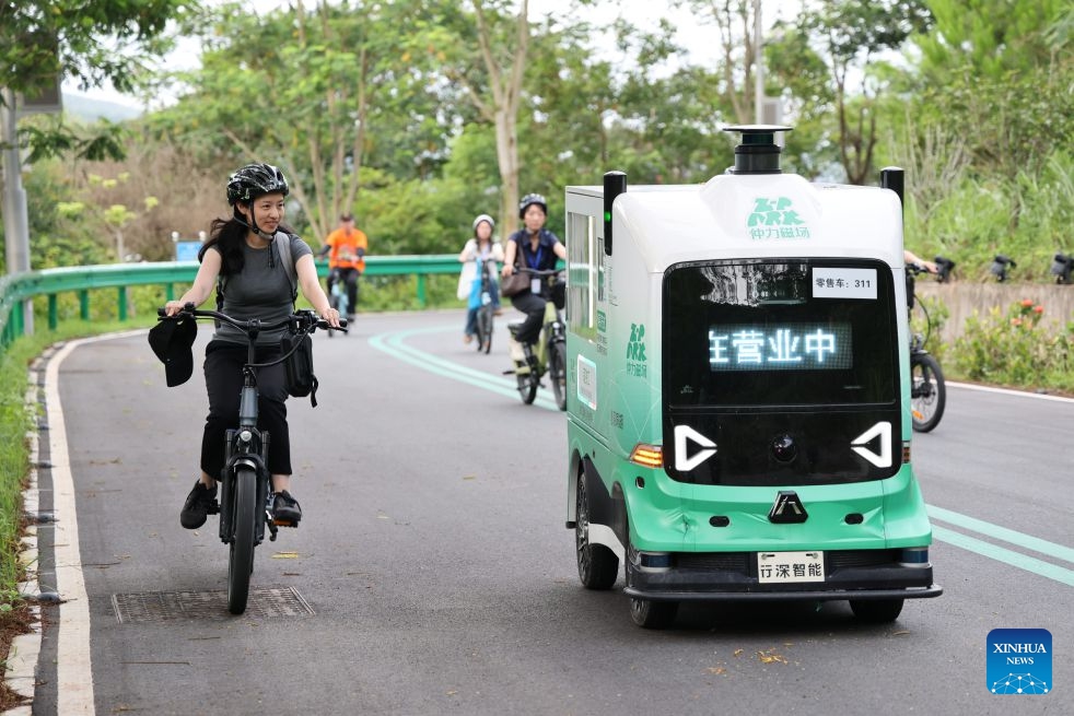 People take test rides of ADO e-bike along a lakeside greenway in Huizhou, south China's Guangdong Province, July 1, 2026. Huizhou Ruijianxing New Energy Technology Co., Ltd. is an e-bike manufacturer headquartered in Huizhou. Its brand, ADO e-bike, integrates AI-powered sensing technology to make riding smarter and safer. (Photo: Xinhua)