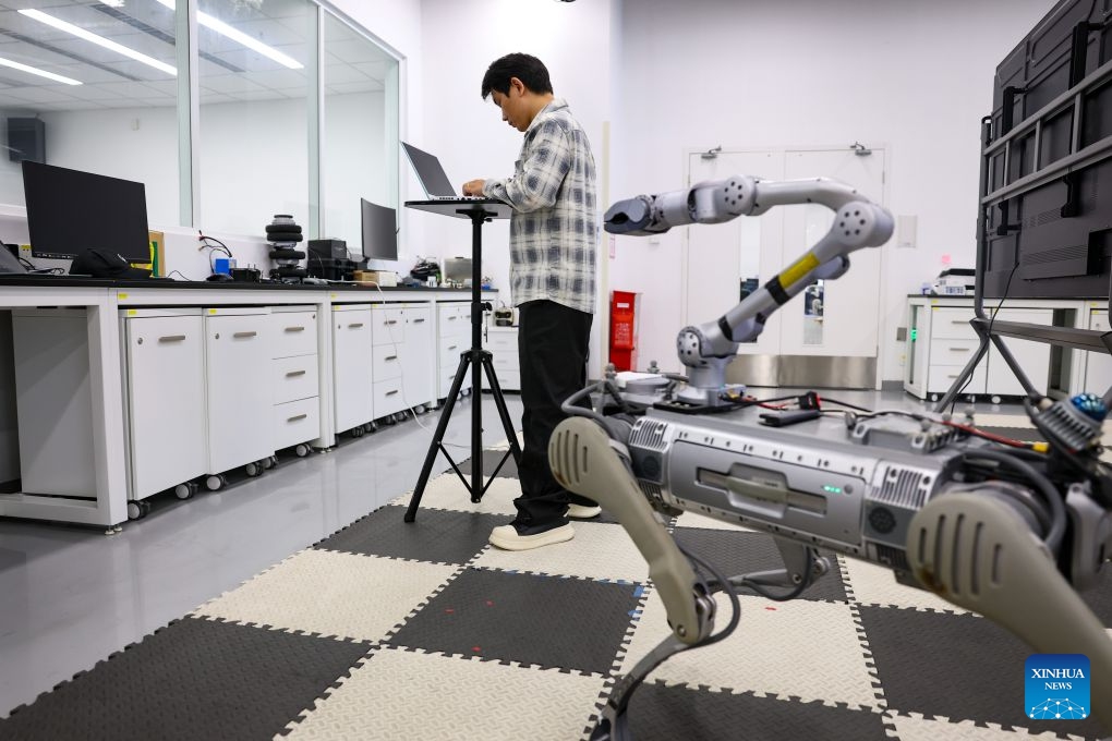 A student tests a robot at the Intelligent Autonomous Driving Center of the Hong Kong University of Science and Technology (Guangzhou) in Guangzhou, south China's Guangdong Province, June 30, 2026. Hong Kong University of Science and Technology (Guangzhou), which opened in 2022, has adopted an innovative academic structure featuring Hubs and Thrusts instead of traditional schools and departments, aiming to foster an interdisciplinary education model and advance emerging disciplines. (Photo: Xinhua)