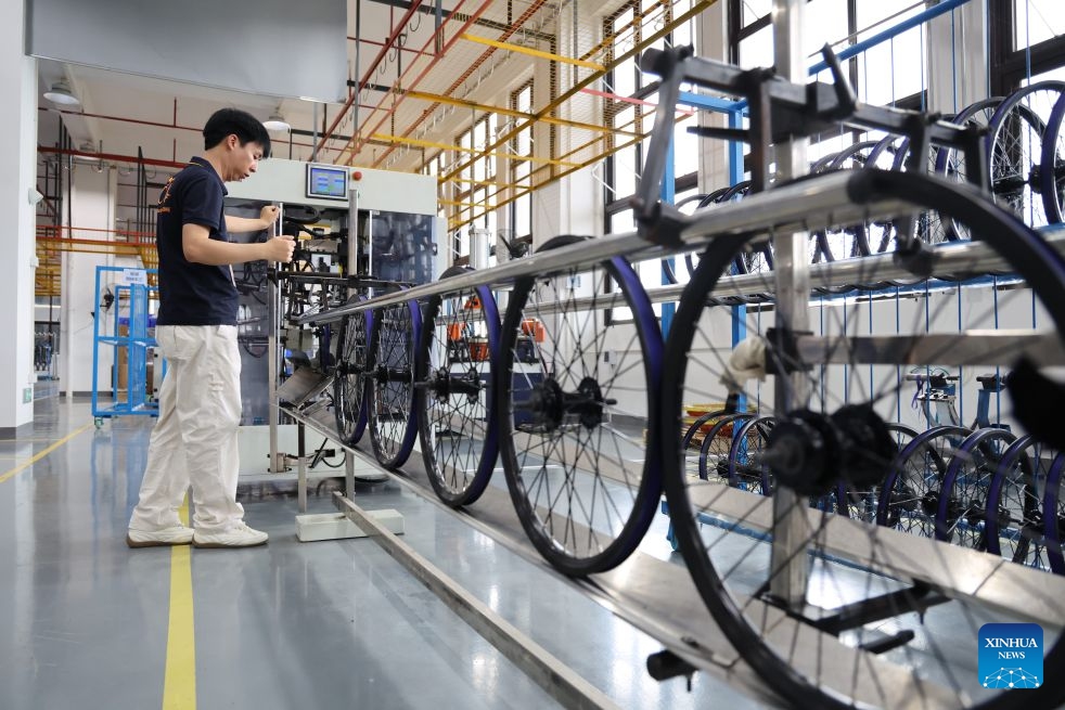 A staff member works at the ADO e-bike workshop of Huizhou Ruijianxing New Energy Technology Co., Ltd. in Huizhou, south China's Guangdong Province, July 1, 2026. Huizhou Ruijianxing New Energy Technology Co., Ltd. is an e-bike manufacturer headquartered in Huizhou. Its brand, ADO e-bike, integrates AI-powered sensing technology to make riding smarter and safer. (Photo: Xinhua)