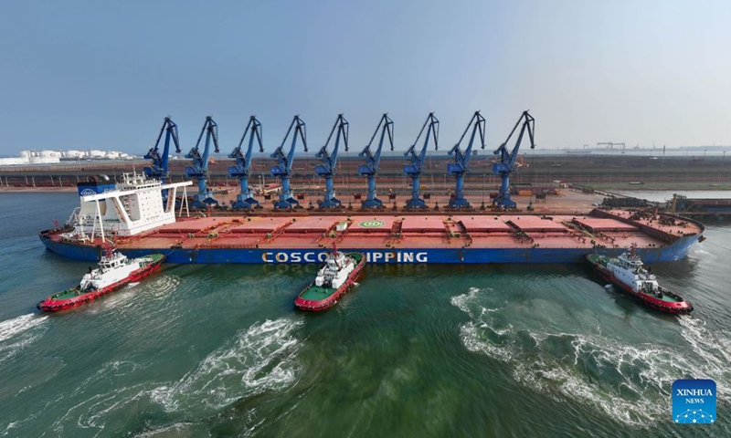 A drone photo taken on July 1, 2026 shows CSB Glory, a bulk carrier under COSCO Shipping, docking an ore terminal of the Tianjin Port in north China's Tianjin. Measuring 330 meters long and 57 meters wide, the bulk carrier under COSCO Shipping set a new record on Wednesday with its maximum draft of 22.18 meters among all ships ever docked at Tianjin Port. (Photo: Xinhua)