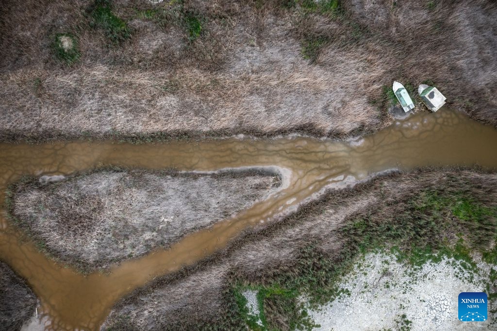 An aerial drone photo taken on July 1, 2026 shows a view of Lake Velence near Pakozd, Hungary. Due to weeks of scorching temperatures and years of dry weather, Lake Velence near Pakozd, Hungary is experiencing a severe drought. The lake's water level has dropped to 47 centimeters, the lowest level ever recorded. (Photo: Xinhua)