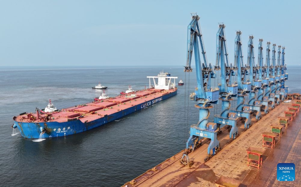 A drone photo taken on July 1, 2026 shows CSB Glory, a bulk carrier under COSCO Shipping, about to dock an ore terminal of the Tianjin Port in north China's Tianjin. Measuring 330 meters long and 57 meters wide, the bulk carrier under COSCO Shipping set a new record on Wednesday with its maximum draft of 22.18 meters among all ships ever docked at Tianjin Port. (Photo: Xinhua)
