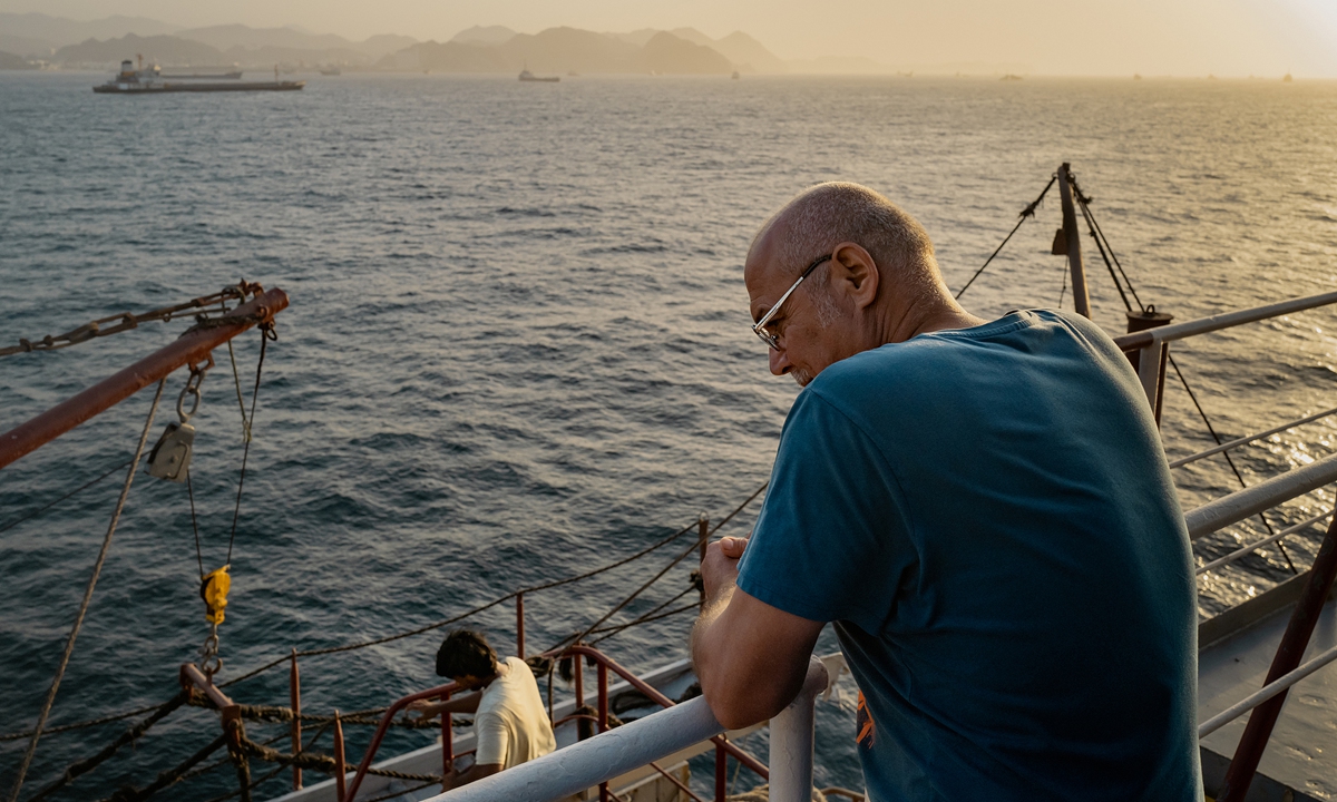 An engineer continues his work after being stranded aboard his cargo vessel for days due to the blockade of the Strait of Hormuz, on June 23, 2026.