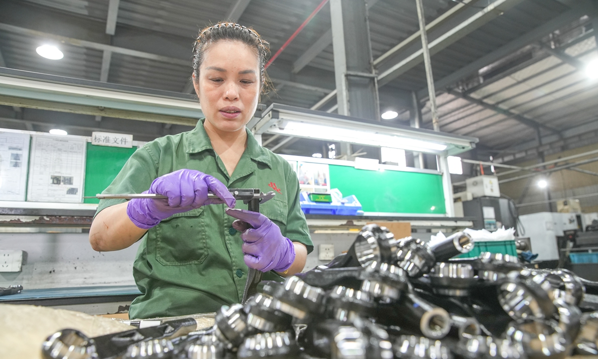 A worker makes new-energy vehicle (NEV) parts bound for Europe at a factory in Huzhou, East China's Zhejiang Province, on July 3, 2026. According to customs data compiled by the China Association of Automobile Manufacturers, China's auto parts exports reached $32.62 billion in the first four months of 2026, up 5.2 percent year-on-year. Photo: VCG