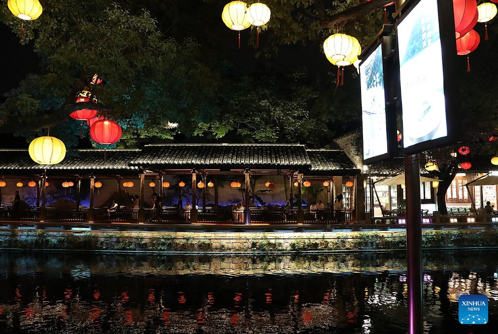 People enjoy the night scenery in Huishan Yingyueli area in Wuxi City, east China's Jiangsu Province on July 2, 2026. Opened in 2025, the Huishan Yingyueli area, inspired by the famous Erhu solo piece Er Quan Ying Yue (Two Springs Reflecting the Moon), is now a beloved local leisure resort. (Xinhua/Lu Peng)