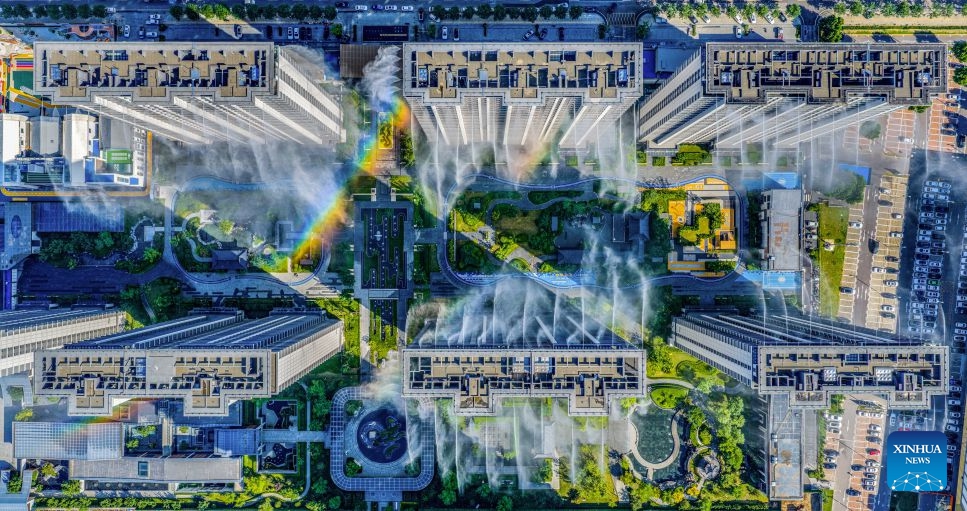 A drone photo taken on July 3, 2026 shows a rooftop misting system at a residential community in Yuncheng City, north China's Shanxi Province. Amid hot weather, the community has activated the misting system to keep the area cool. (Photo: Xinhua)