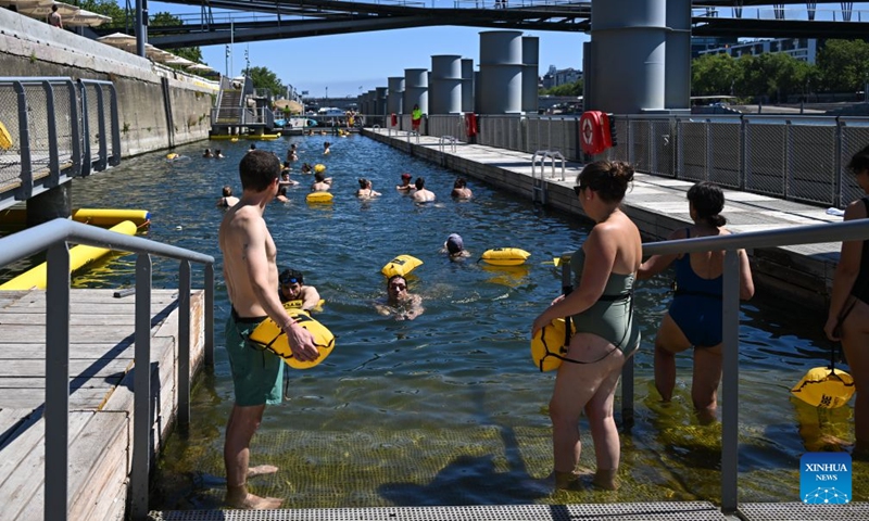 People swim in the Seine River, Paris, France, on July 4, 2026. Paris opened some swimming sites in the Seine River to help people escape heat on Saturday. (Photo by Emma Da Silva/Xinhua)