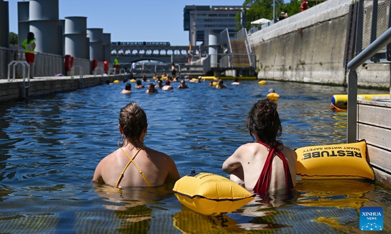 People swim in the Seine River, Paris, France, on July 4, 2026. Paris opened some swimming sites in the Seine River to help people escape heat on Saturday. (Photo by Emma Da Silva/Xinhua)