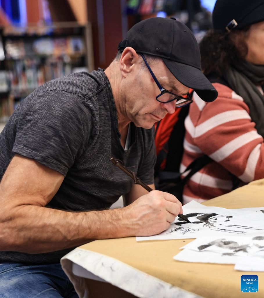 A man tries his hands with traditional Chinese painting during a Chinese Language Week event in Wellington, New Zealand on July 4, 2026. (Photo by Meng Tao/Xinhua)

