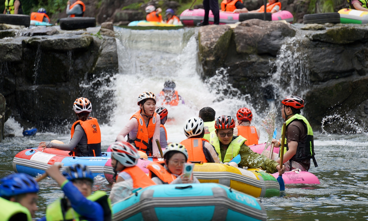 Tourists enjoy a rafting experience in the Zhengjiangshan Canyon in Yueqing, East China's Zhejiang Province on July 5, 2026. During midsummer, many visitors flocked to the canyon to immerse themselves in the natural landscape and enjoy the cool waters while rafting. Photo: VCG