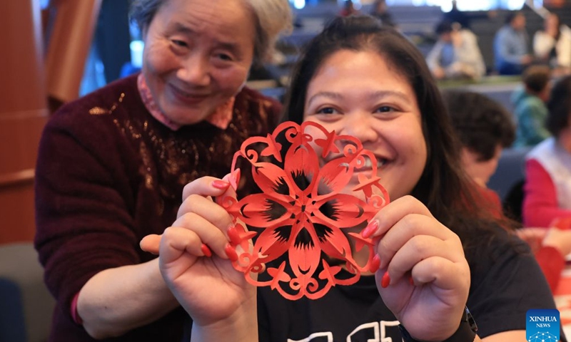 People show a Chinese paper-cutting work during a Chinese Language Week event in Wellington, New Zealand on July 4, 2026. (Photo by Meng Tao/Xinhua)


