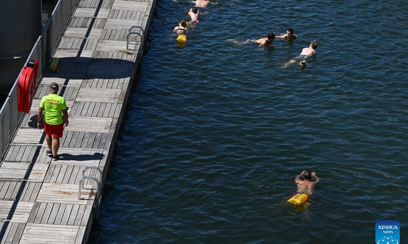 People swim in the Seine River, Paris, France, on July 4, 2026. Paris opened some swimming sites in the Seine River to help people escape heat on Saturday. (Photo by Emma Da Silva/Xinhua)