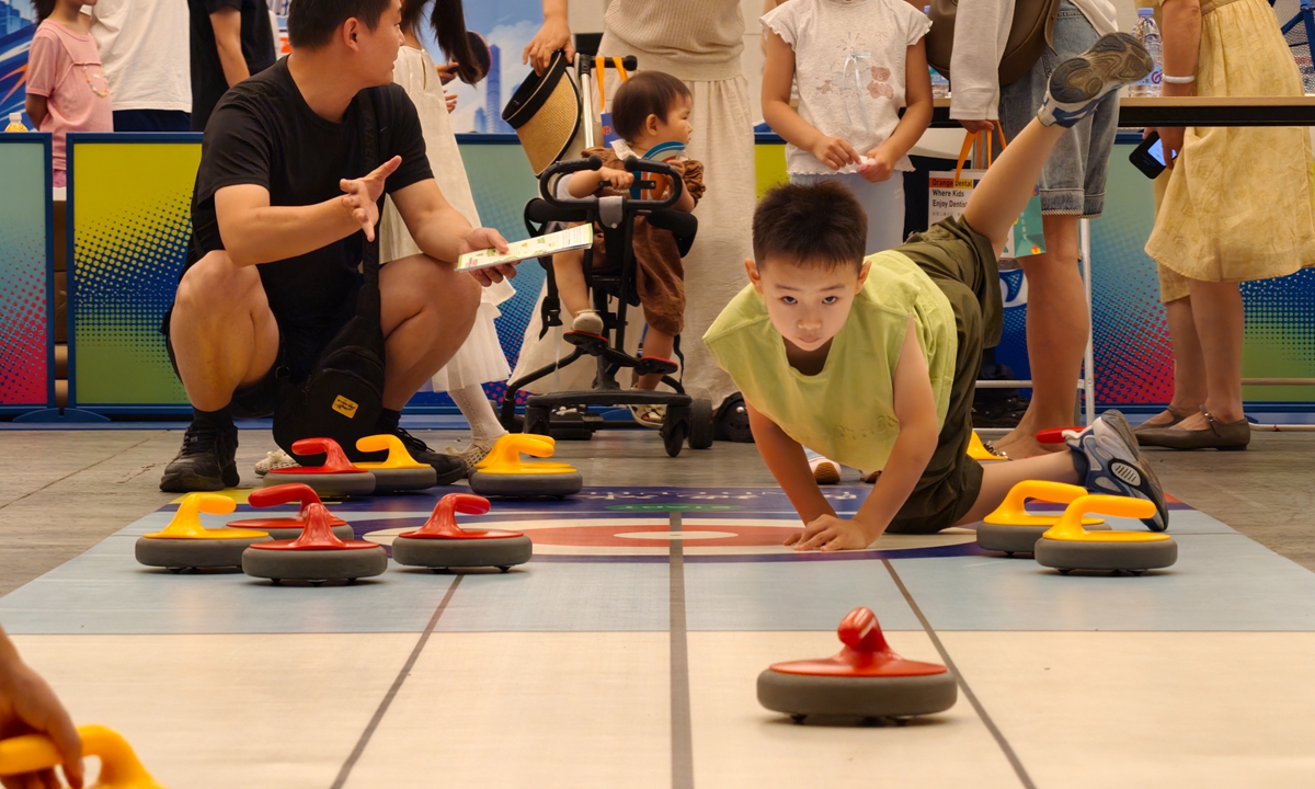 A child tries dryland curling during the opening of the 5th Tianjin Summer Sports Festival for Children on July 5, 2026. The event features sports competitions, health education, interactive activities and a cultural market, offering young participants a summer festival combining athletics, learning and recreation. Photo: VCG