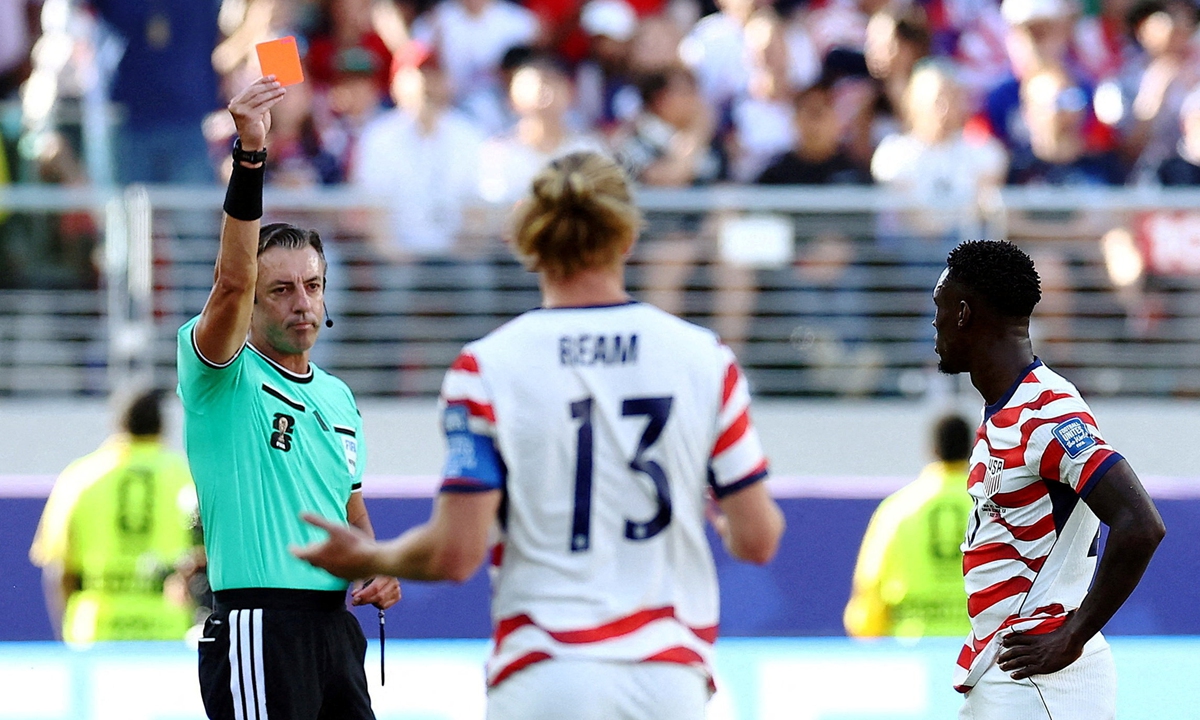 US forward Folarin Balogun (right) receives a straight red card from referee Raphael Klaus during their 2026 World Cup Round of 32 clash against Bosnia and Herzegovina. Photo: IC