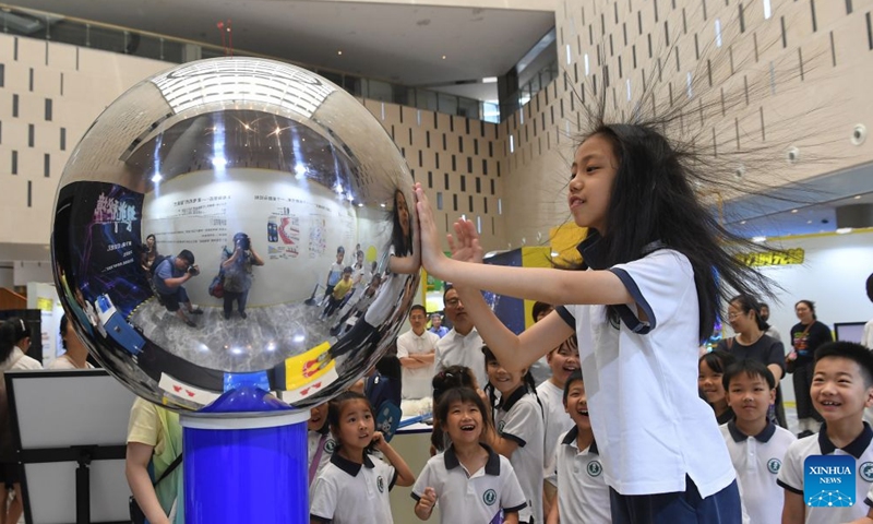 A child interacts with a science popularization equipment at a museum in Jinhua, east China's Zhejiang Province, July 5, 2026. (Photo by Shi Kuanbing/Xinhua)