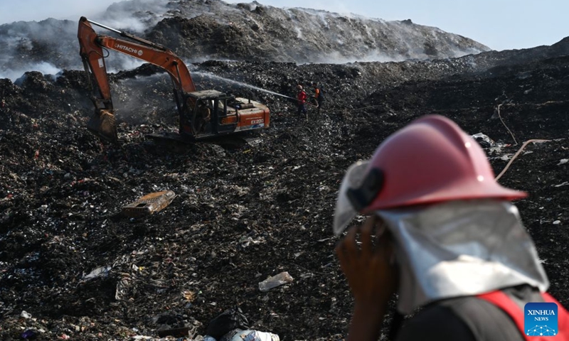Firefighters attempt to put out a fire at a smoldering landfill in Tangerang Regency of Banten Province, Indonesia on July 5, 2026.