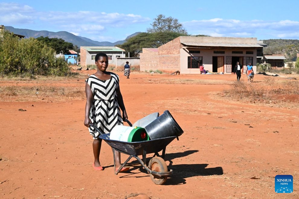 A woman pushes a wheelbarrow towards a China-aided borehole to fetch water in Bumba Village, Manicaland, Zimbabwe, June 29, 2026. (Photo: Xinhua)
