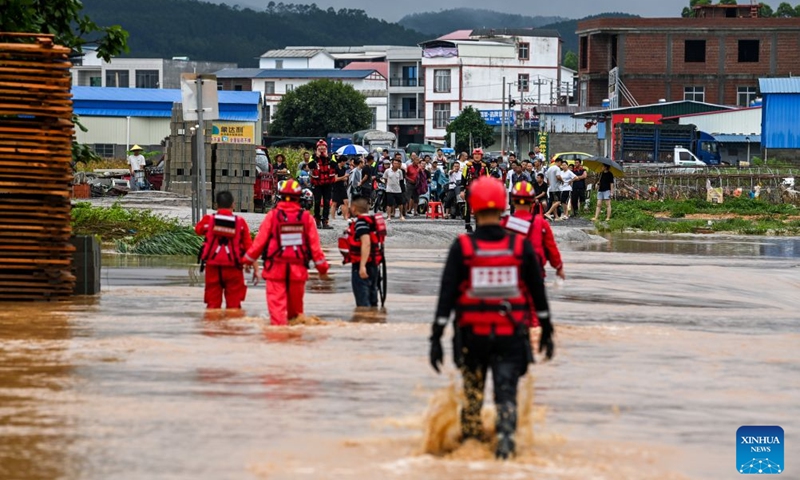 Rescuers wade through floodwaters during rescue operations in Hengzhou of Nanning City, south China's Guangxi Zhuang Autonomous Region, July 6, 2026. Record-breaking rainfall and the ensuing floods in parts of Nanning, capital city of south China's Guangxi Zhuang Autonomous Region, have left four people dead and eight others missing as of 10 a.m. Tuesday, according to a press conference on flood prevention and disaster relief held in Nanning. Hengzhou City and Binyang County, both currently under the jurisdiction of Nanning, recently experienced rainfall that broke local 24-hour meteorological records. The reported casualties were all in Hengzhou. (Xinhua/Cao Yiming)