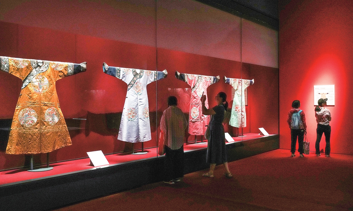 Visitors view Qing Dynasty (1644-1911) court costumes at an exhibition in Shanghai on July 7, 2026. The exhibition features 101 pieces, nearly 90 percent of which are on display outside Beijing for the first time. Photo: VCG
