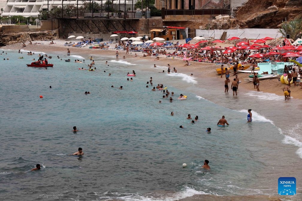 People enjoy themselves on the beach in Byblos, Lebanon, July 5, 2026. (Photo: Xinhua)