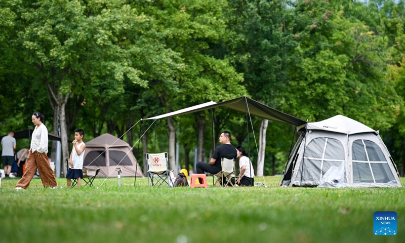 People camp at the Hutuo River ecological zone in Shijiazhuang, north China's Hebei Province, July 5, 2026. Shijiazhuang has developed a camping-based tourism brand to enrich short-getaway options for tourists, boost consumption and promote rural revitalization. (Photo: Xinhua)