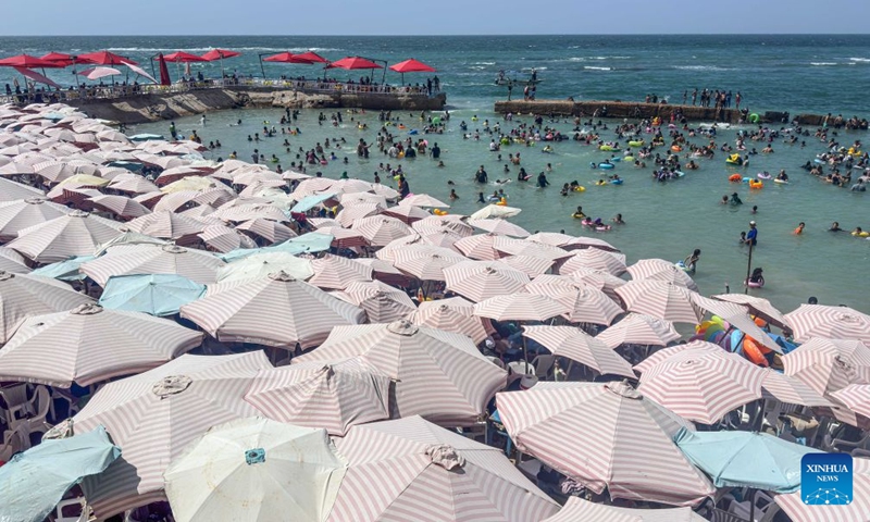 People cool off on a beach along the Mediterranean coast during a heatwave in Alexandria, Egypt, on July 6, 2026. (Photo: Xinhua)