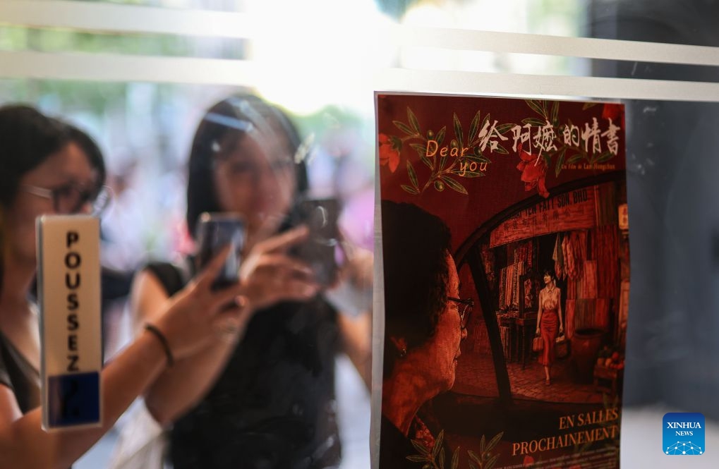 People take photos of a poster of the Chinese film Dear You in Paris, France, July 5, 2026. China's word-of-mouth movie sensation Dear You held its French premiere in Paris on Sunday. (Photo: Xinhua)