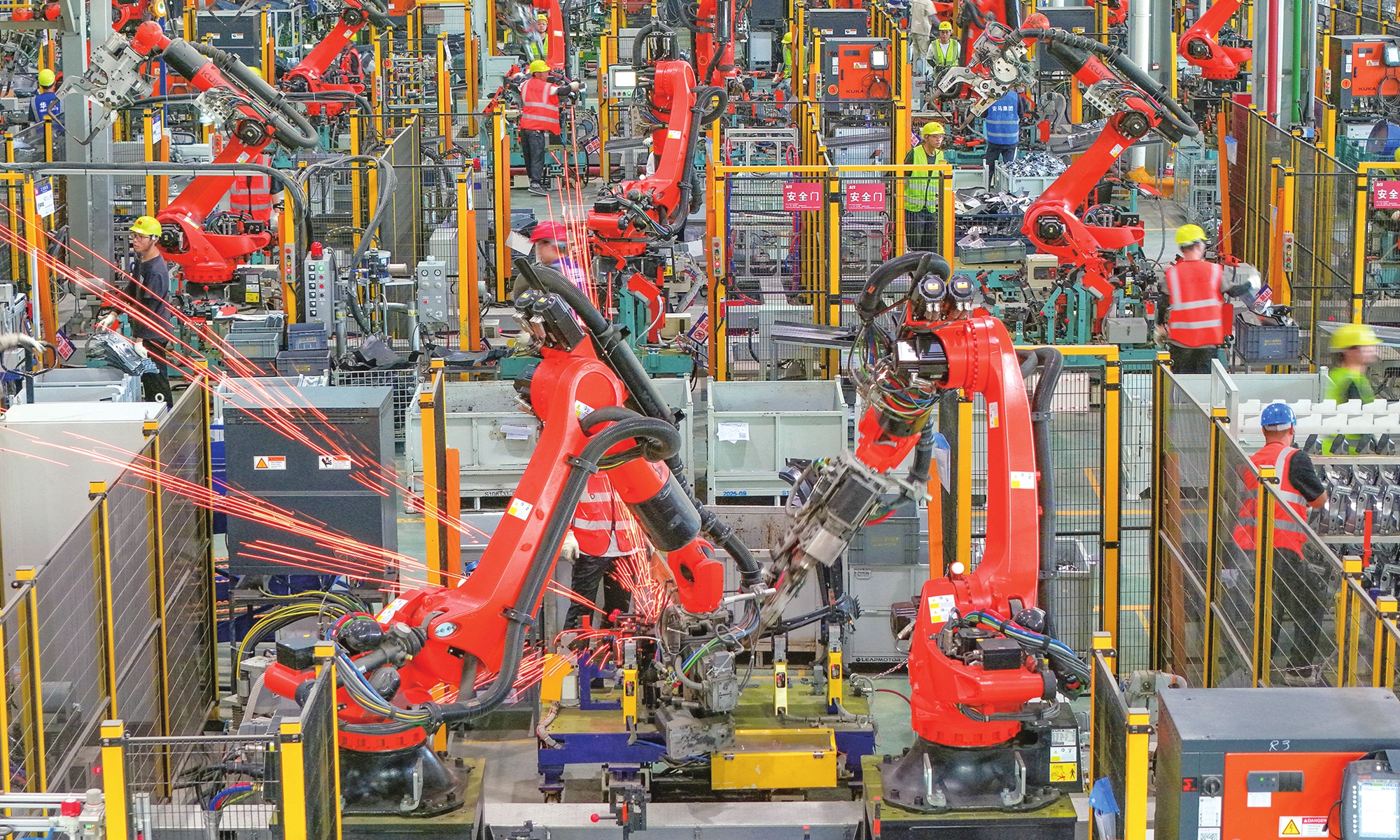Workers fulfill orders for new-energy vehicle parts with industrial robots operating at full speed at a tech company in Jinhua, East China's Zhejiang Province on July 7, 2026. At the start of the third quarter, the company ramped up efforts to boost production, enhancing both the capacity and precision of its components. Photo: VCG