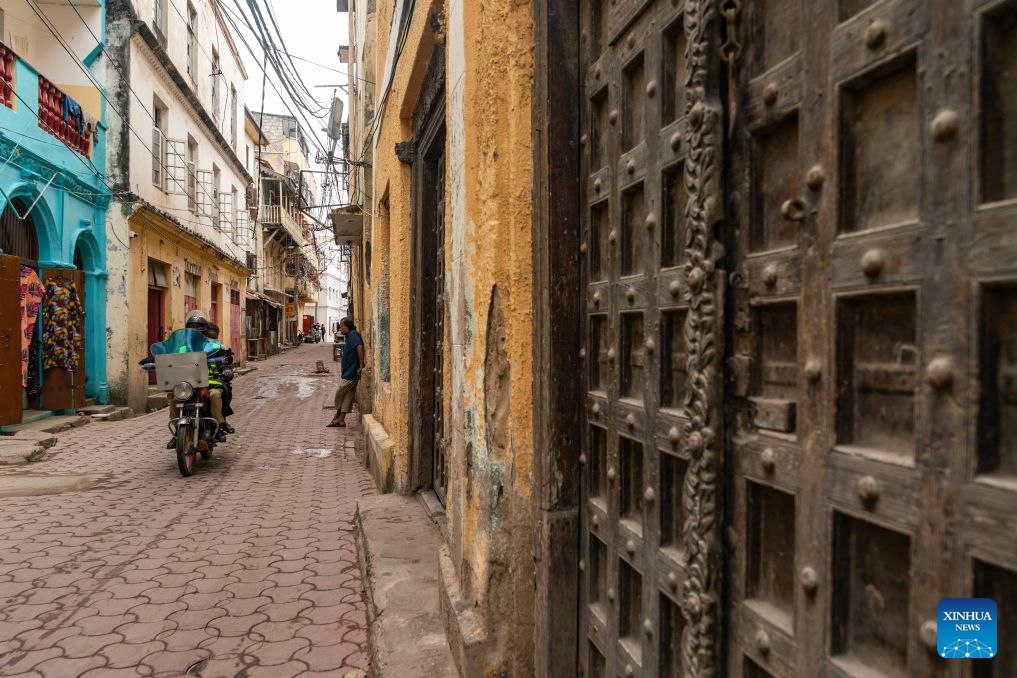 People ride a motorcycle on a street in the Old Town of Mombasa, Kenya, July 7, 2026. The Old Town of Mombasa, located on the southeastern side of Mombasa Island in Kenya, was once home to Swahili, Arab, Portuguese and other communities. As one of the best-preserved historic Swahili districts in East Africa, it remains an important center for preserving and showcasing Swahili culture. Rich in multicultural heritage and historical landmarks, the Old Town is also one of Kenya's major tourist destinations. (Photo: Xinhua)