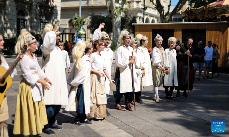 Artists promote a drama on the street during the 80th Festival d'Avignon in Avignon, France, July 7, 2026. The festival, created in 1947 by French drama director Jean Vilar, is one of the most important contemporary performing arts events in the world. (Photo: Xinhua)