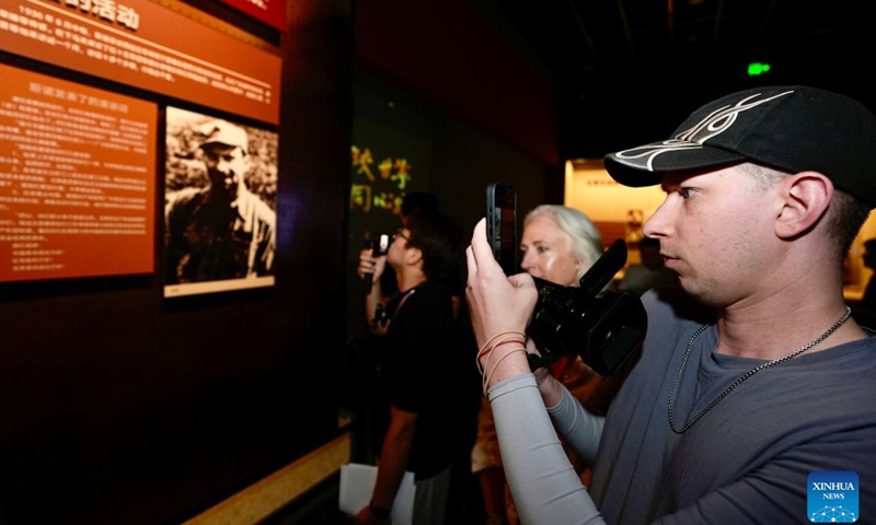 A family member (R) of Edgar Snow visits a memorial hall of the Red Army in Tongxin County, northwest China's Ningxia Hui Autonomous Region, July 6, 2026. Chinese and foreign participants, including family members of U.S. journalist Edgar Snow, visited Tongxin from July 6 to 7 during an event themed Retracing Snow's Route. The event was organized by the Xinhua Institute, a think tank affiliated with Xinhua News Agency, and the School of Journalism and Communication and the China Center for Edgar Snow Studies at Peking University. (Photo: Xinhua)