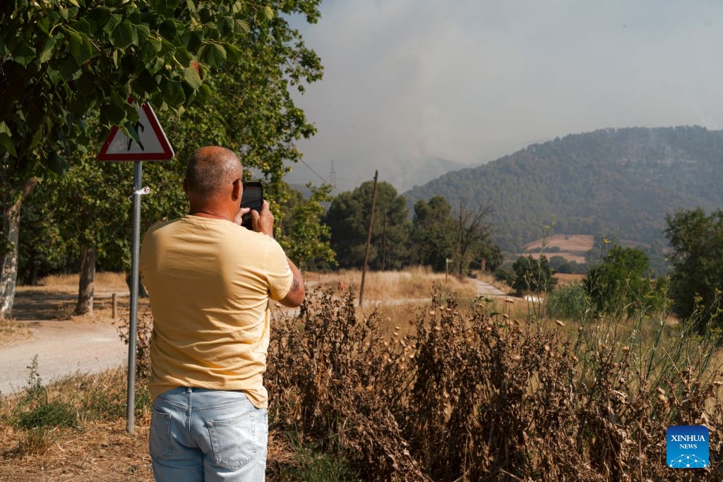 A man observes a wildfire in Sentmenat, Barcelona, Spain, on July 7, 2026. According to satellite-based estimates from the European Forest Fire Information System (EFFIS), wildfires have burned around 56,000 hectares in Spain so far this year. (Photo: Xinhua)