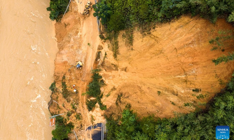 An aerial drone photo taken on July 7, 2026 shows emergency restoration of a damaged highway in Qingshan Village of Jinxiu Yao Autonomous County, Laibin City, south China's Guangxi Zhuang Autonomous Region. Recent extreme rainstorms triggered by Typhoon Maysak, the 10th typhoon of the year, have caused severe flooding in parts of south China's Guangxi Zhuang Autonomous Region. Traffic of several national and provincial highways in Jinxiu Yao Autonomous County has been disrupted. Emergency restoration of the damaged roads is underway. (Photo: Xinhua)