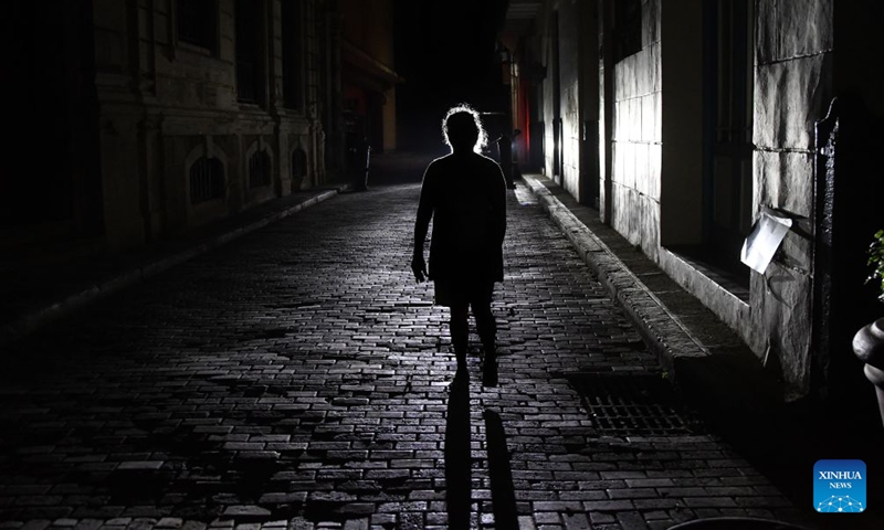 A pedestrian walks down a dark street amid a nationwide blackout, in Havana, the capital of Cuba, on July 6, 2026. Cuba's state-run National Electric Union said Monday that the country's national power system suffered a total outage. (Photo: Xinhua)