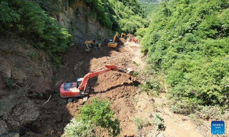 An aerial drone photo taken on July 7, 2026 shows rescuers working at the site of a landslide in a village in Nanhe Township, Tanchang County, Longnan City, northwest China's Gansu Province. China's Ministry of Emergency Management activated a Level-IV national emergency response for geological disasters in northwest China's Gansu Province and dispatched a working team to guide rescue and relief efforts after a landslide struck a village on Tuesday, leaving multiple people buried and dead. The landslide occurred at around 6:56 a.m. in a village in Nanhe Township, Tanchang County, Longnan City, according to local authorities. (Photo: Xinhua)