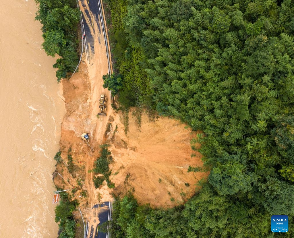 An aerial drone photo taken on July 7, 2026 shows emergency restoration of a damaged highway in Qingshan Village of Jinxiu Yao Autonomous County, Laibin City, south China's Guangxi Zhuang Autonomous Region. (Photo: Xinhua)