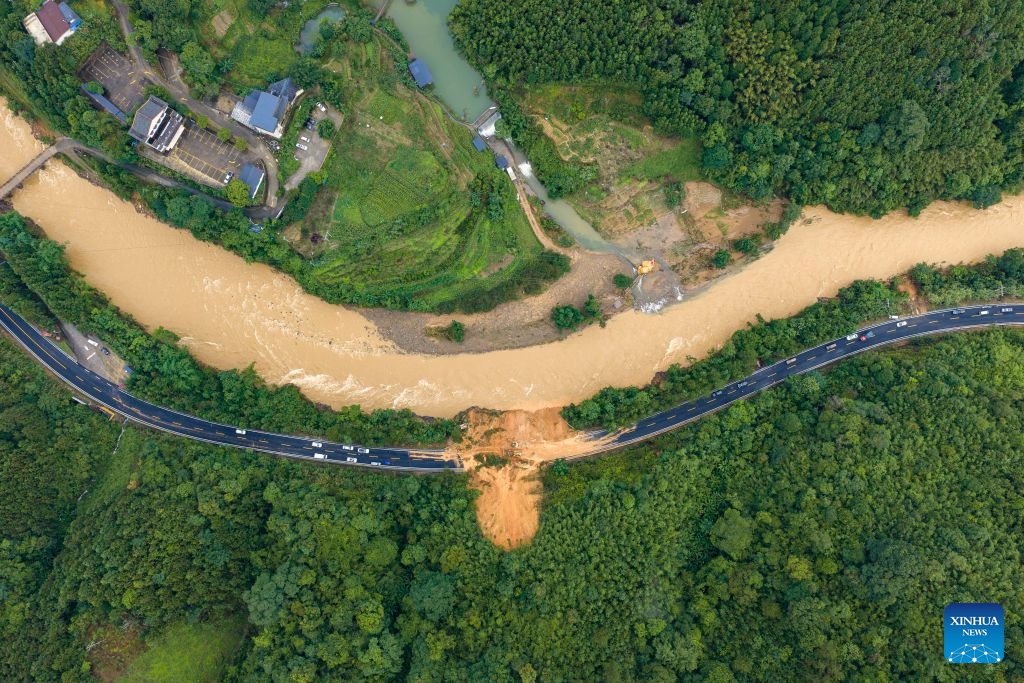 An aerial drone photo taken on July 7, 2026 shows emergency restoration of a damaged highway in Qingshan Village of Jinxiu Yao Autonomous County, Laibin City, south China's Guangxi Zhuang Autonomous Region. (Photo: Xinhua)