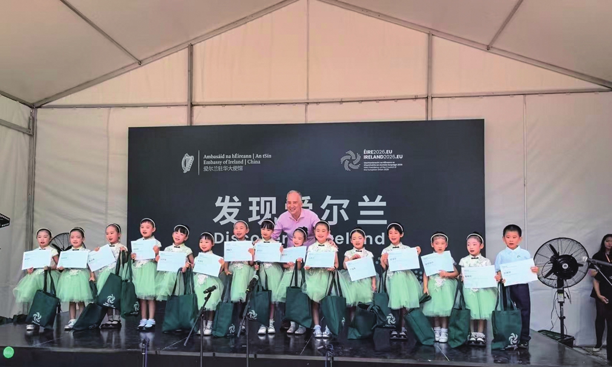 Nicholas O'Brien, ambassador of Ireland to China (center), and children chorus members pose for a group picture after the opening performance on July 4, 2026. Photo: Dong Feng/GT    