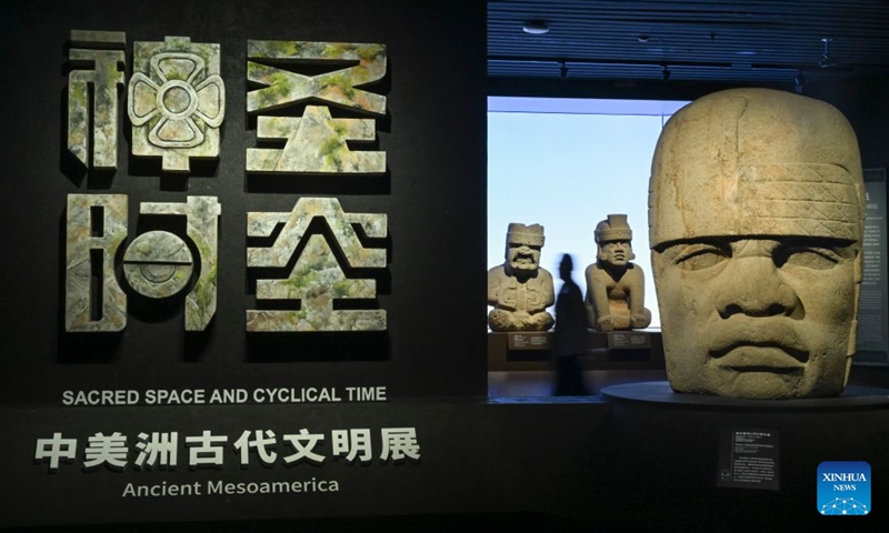 A visitor views exhibits during the exhibition On Top of the World Tree: Ancient Civilizations of the Americas in Shanghai, east China, July 8, 2026. The exhibition showcases a total of 1,129 sets of precious artifacts from cultural institutions in Mexico, Peru and China. It will officially open to the public on July 9 and will run until Nov. 14, 2027. (Photo: Xinhua)