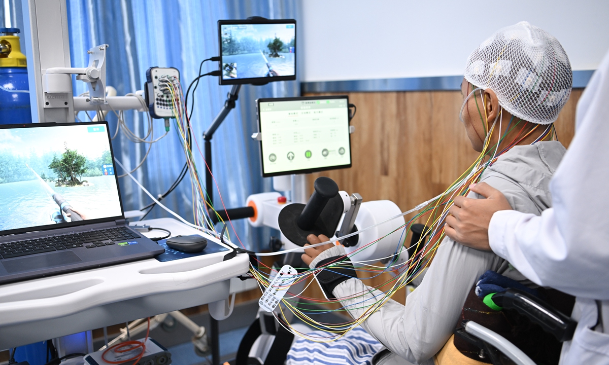 A patient receives treatment on July 9, 2026, at the first high?altitude brain?computer interface (BCI) clinical application center, which was inaugurated in Lhasa, Southwest China's Xizang Autonomous Region on the same day. Adopting cutting-edge non-invasive rehabilitation technologies, the center specializes in rehabilitation for limb dysfunction caused by nerve injuries, filling a gap in relevant medical sectors across Xizang. Photo: VCG