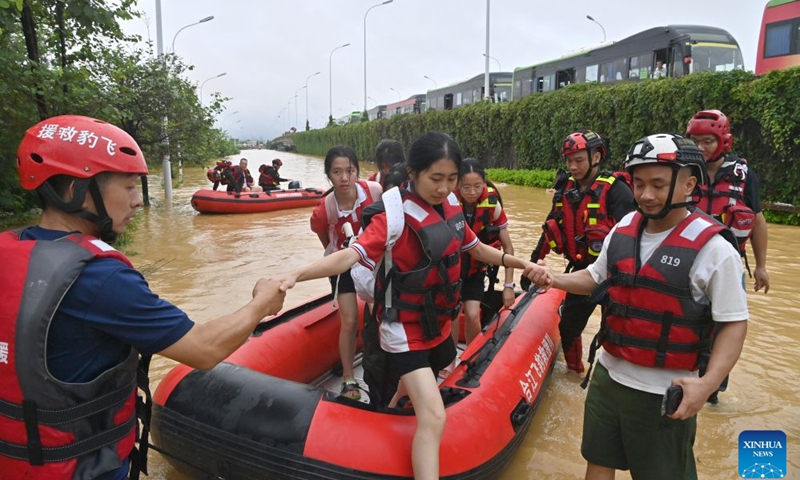 Rescuers evacuate stranded teachers and students at Xijiang education park in Guigang City, south China's Guangxi Zhuang Autonomous Region, July 8, 2026. The torrential rains caused by Typhoon Maysak left many school personnel and students trapped by floods at Xijiang education park in Guigang. Local authorities organized rescue forces to evacuate stranded teachers and students here on Wednesday. (Photo: Xinhua)