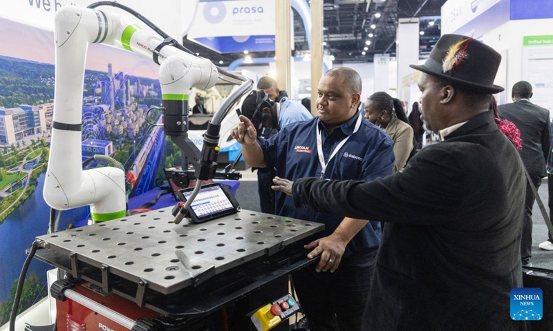 People communicate during the Africa Rail 2026 at the Sandton Convention Centre in Johannesburg, South Africa, July 7, 2026. The exhibition, serving as a platform for industry stakeholders to promote the collaborative development of Africa's railway sector, was held here from July 7 to 8. (Photo: Xinhua)