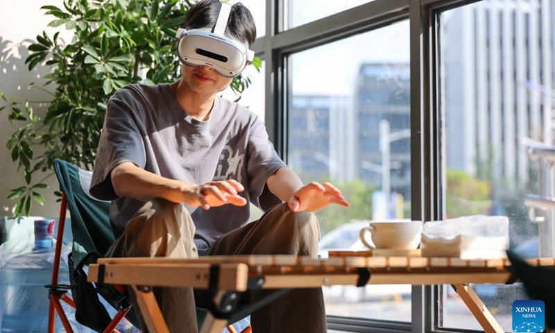 A data collector captures real-world inputs for embodied intelligent devices at a cafe scenario in Yunyan District of Guiyang City, southwest China's Guizhou Province, July 6, 2026. With the rapid development of embodied artificial intelligence (AI), a new profession, trainers of embodied AI, has emerged, which comprise roles such as data collectors. In Guizhou, China's first national comprehensive big data pilot zone, data collectors are producing the essential raw material for the digital economy, bridging the physical and digital worlds. (Photo: Xinhua)