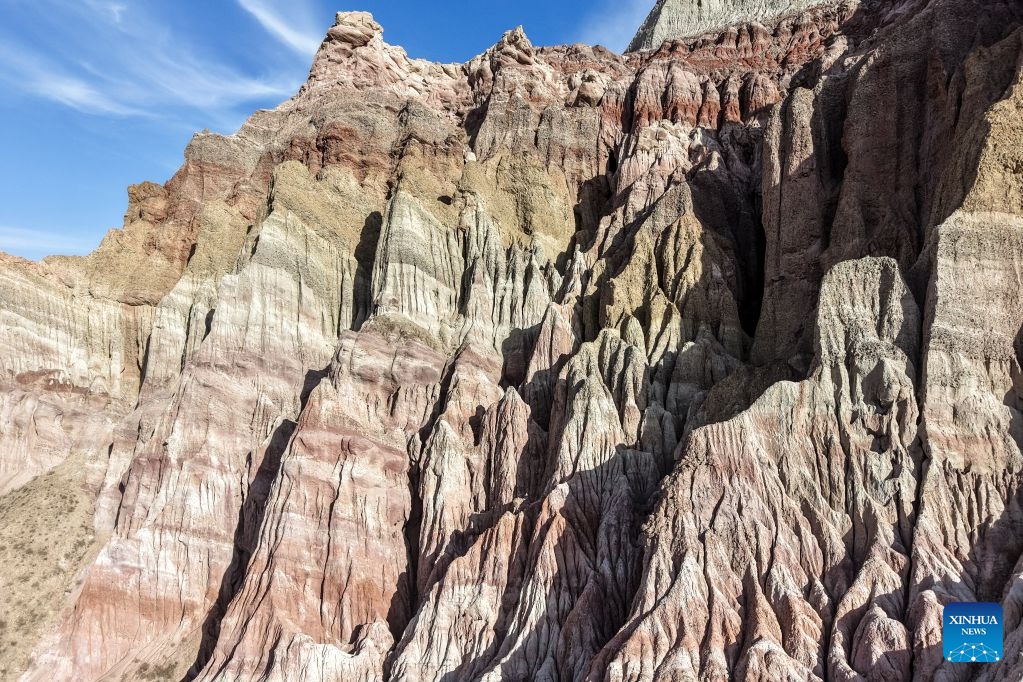 An aerial drone photo taken on July 7, 2026 shows the view of a geopark in Sunan Yugur Autonomous County of Zhangye, northwest China's Gansu Province. The geopark covers an area of 17.34 square kilometers. The park features unique landforms with towering peaks, rugged mountains, jagged rock pillars, and vibrant colors. (Photo: Xinhua)