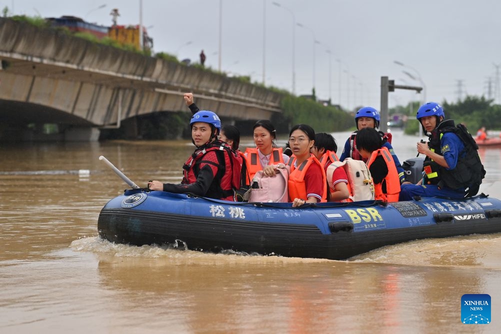 Rescuers evacuate stranded teachers and students at Xijiang education park in Guigang City, south China's Guangxi Zhuang Autonomous Region, July 8, 2026. The torrential rains caused by Typhoon Maysak left many school personnel and students trapped by floods at Xijiang education park in Guigang. Local authorities organized rescue forces to evacuate stranded teachers and students here on Wednesday. (Photo: Xinhua)