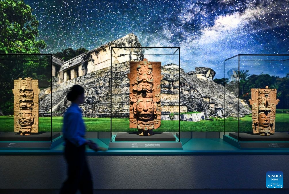 A visitor views exhibits during the exhibition On Top of the World Tree: Ancient Civilizations of the Americas in Shanghai, east China, July 8, 2026. The exhibition showcases a total of 1,129 sets of precious artifacts from cultural institutions in Mexico, Peru and China. It will officially open to the public on July 9 and will run until Nov. 14, 2027. (Photo: Xinhua)