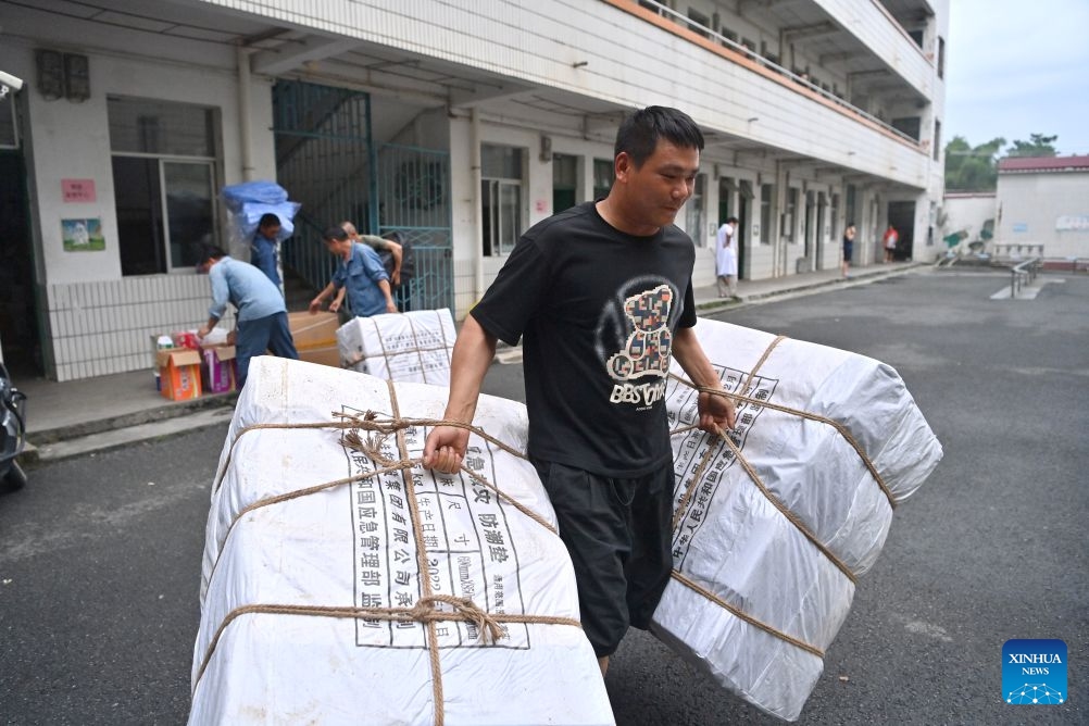 Flood-affected residents receive relief supplies at a temporary relocation site in Guigang City, south China's Guangxi Zhuang Autonomous Region, July 8, 2026. Guigang has set up 18 temporary relocation sites to shelter flood-affected residents. (Photo: Xinhua)